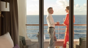 Couple standing on balcony of an Ambassador suite